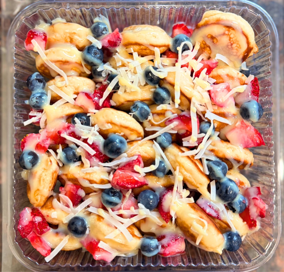 Berry medley mini pancakes with strawberries, blueberries and coconut